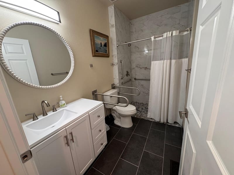 Accessible bathroom with grab bars and roll-in shower