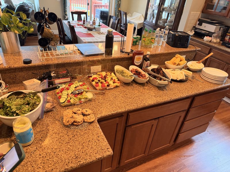 The kitchen mid-service, laid out for a family-style meal