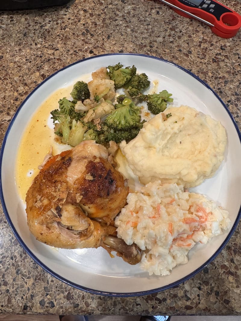 Roasted chicken with mashed potatoes, broccoli, and coleslaw